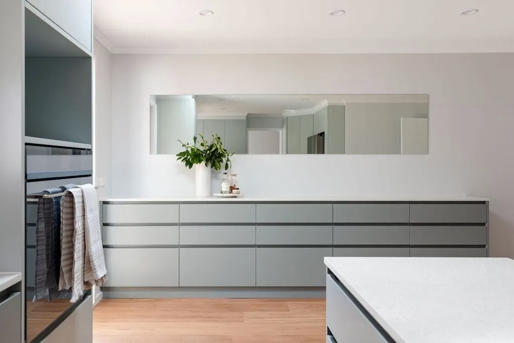 Grey handleless drawer banks and a long bench run in the Belconnen kitchen