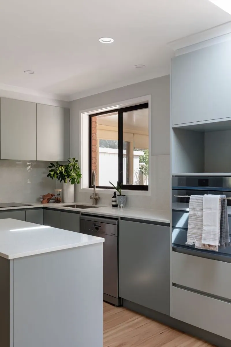 Grey cabinetry, window and dishwasher in the Belconnen kitchen