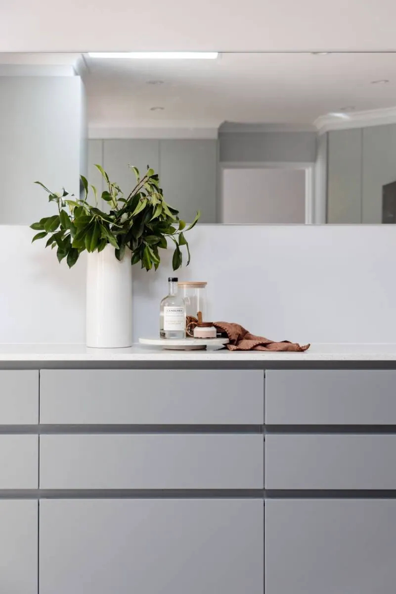 White benchtop and grey drawer banks in the Belconnen kitchen