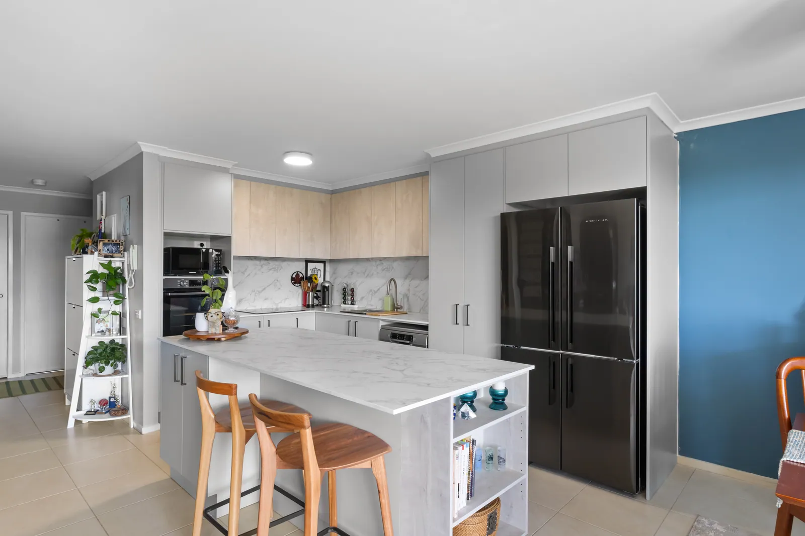 Island bench with seating and open shelving in the Bruce kitchen