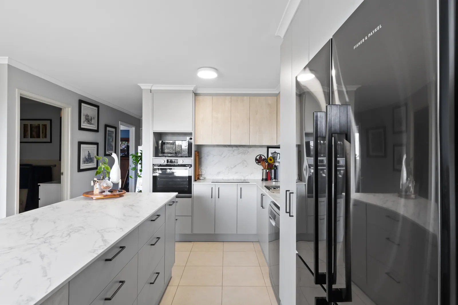 Long stone-look bench in the Bruce kitchen with grey drawer banks