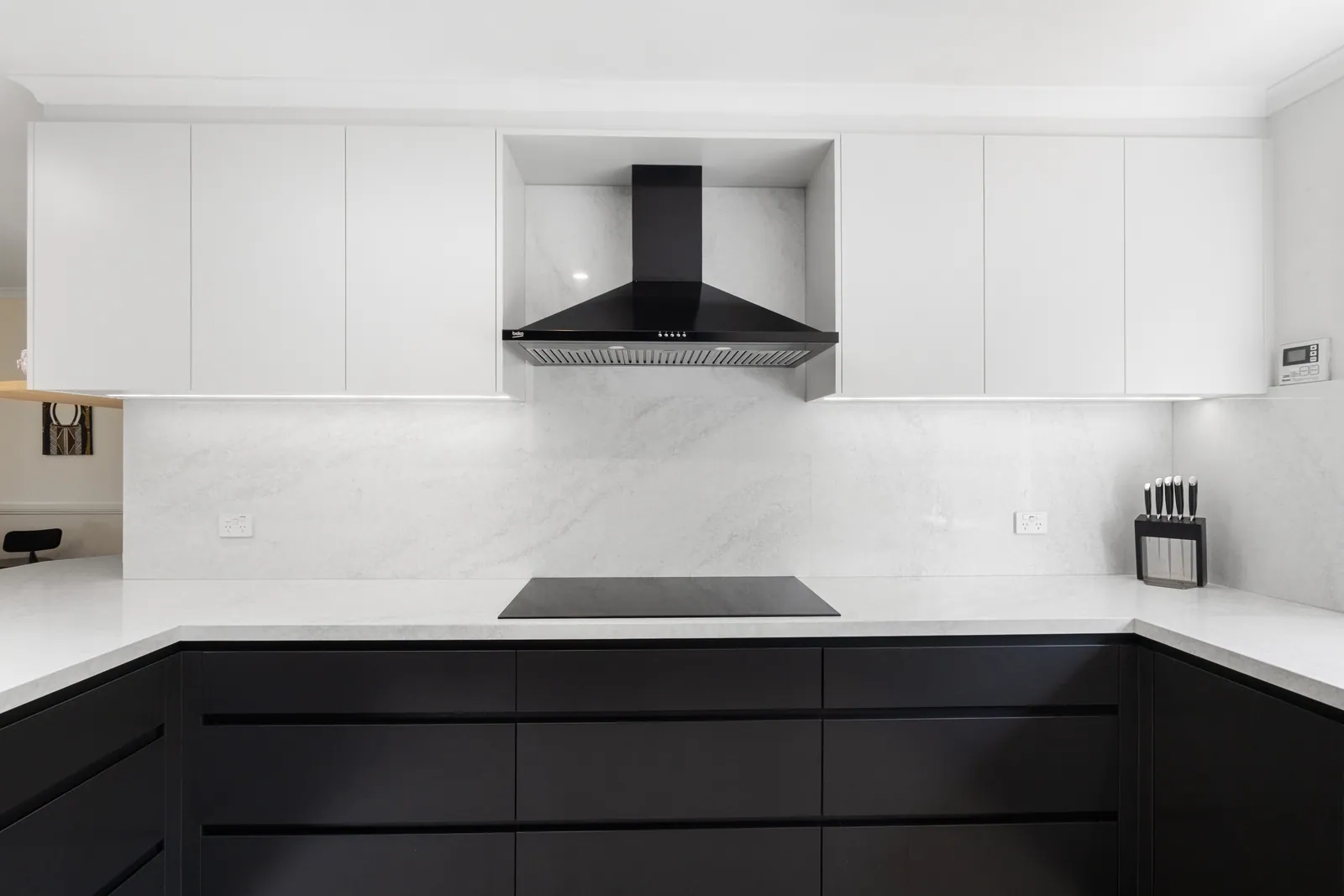 Induction cooktop and rangehood above white cabinetry in the Calwell kitchen