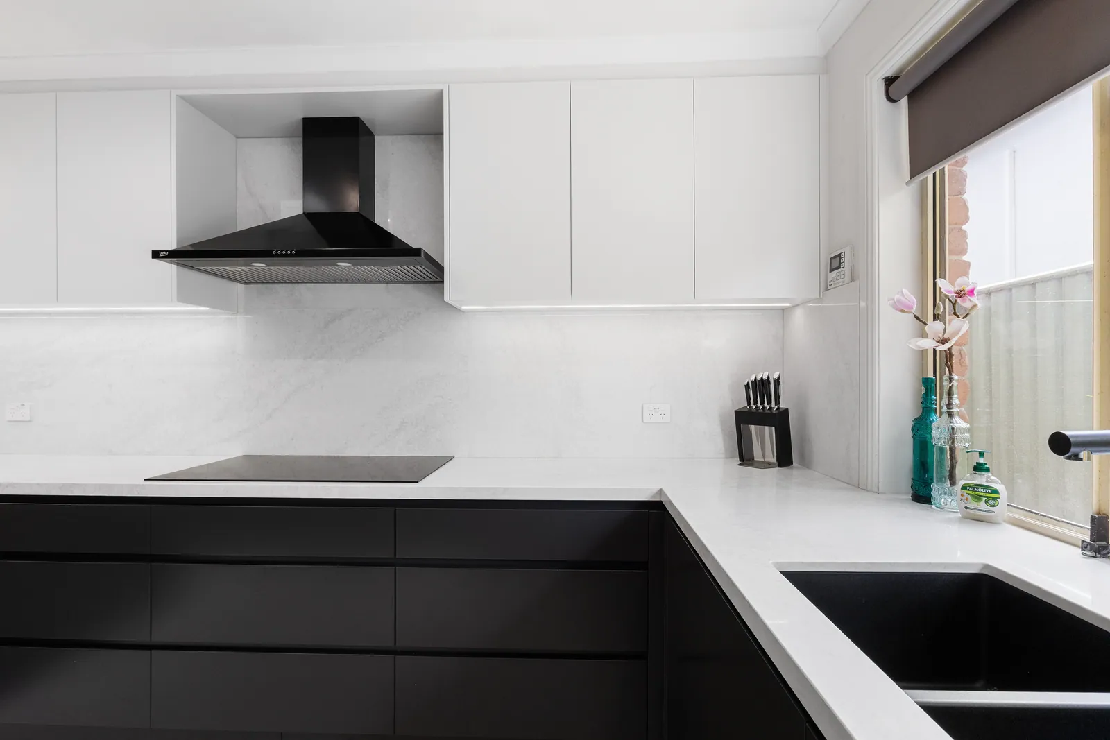 Cooktop and white overhead cabinetry in the Calwell kitchen