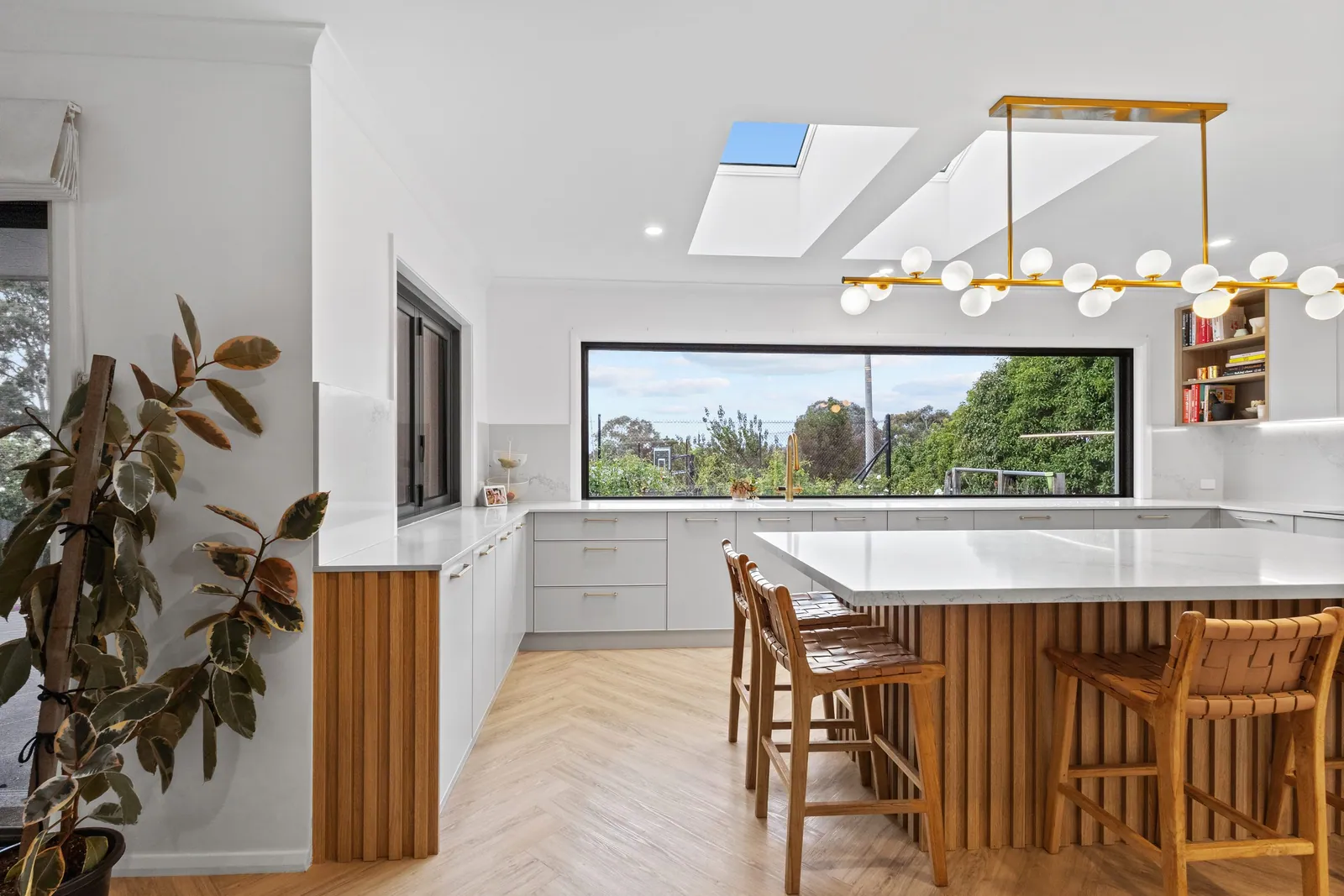 Fluted timber island with seating in the white Chapman kitchen