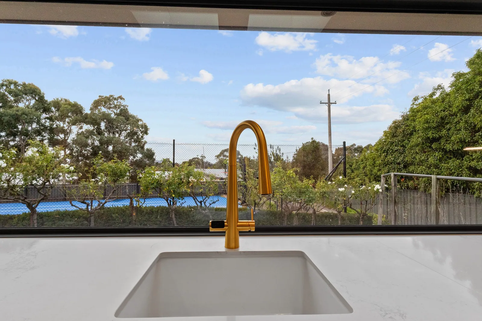 Brass tap and undermount sink at the window in the Chapman kitchen