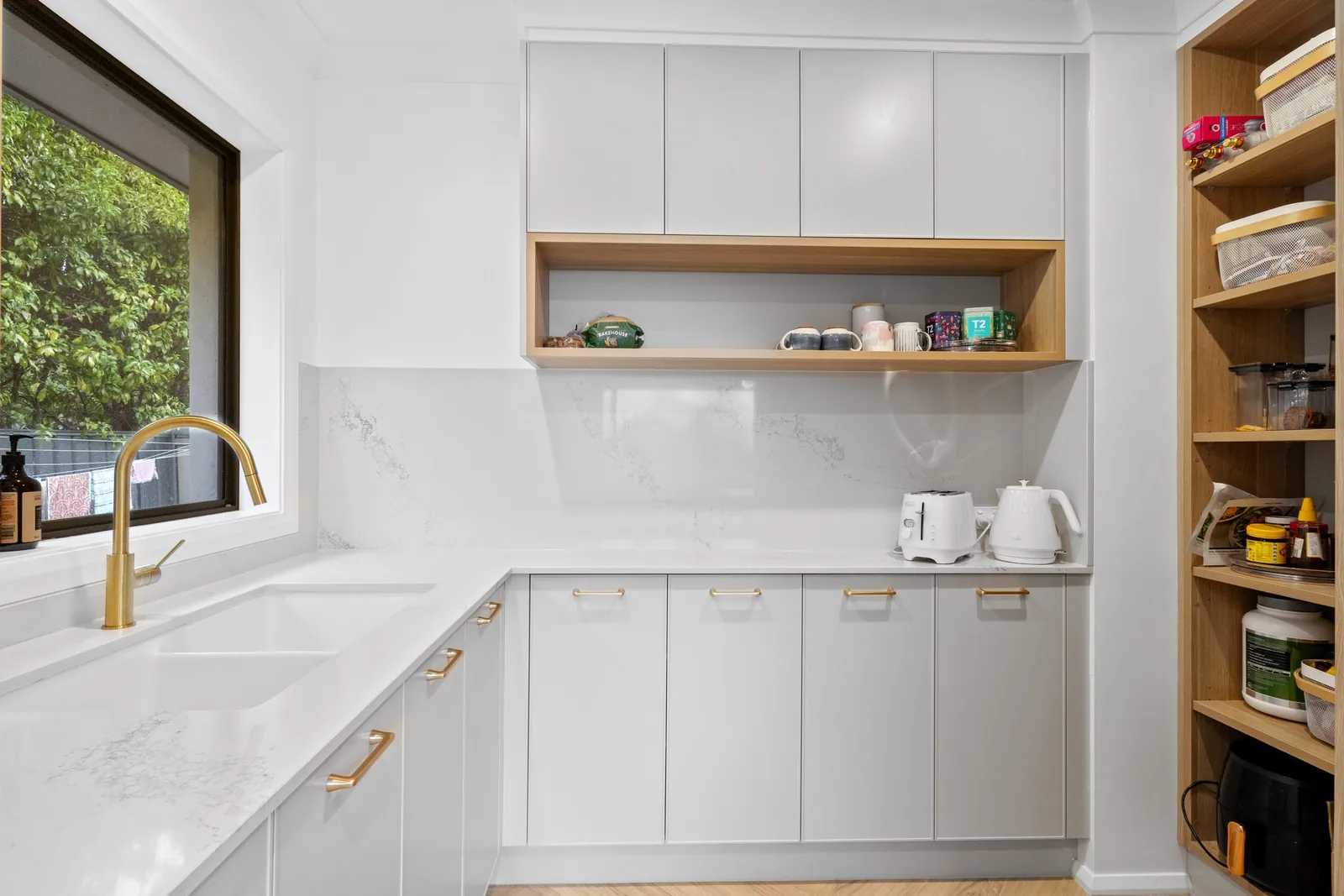 Walk-in pantry with timber shelving beside the Chapman kitchen