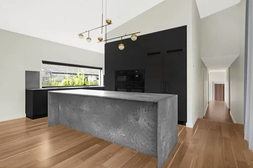 Deakin kitchen with matt black cabinetry and a concrete-look island bench