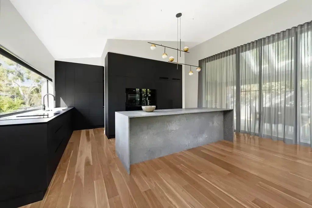 Concrete-look island end and black cabinetry in the Deakin kitchen