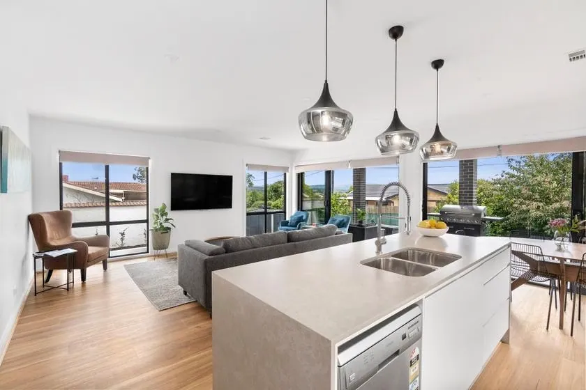 Flynn kitchen island and bench run opening onto the living space