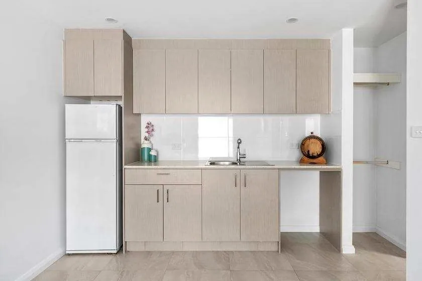 Kitchenette joinery with light cabinetry and open shelving in the Flynn home