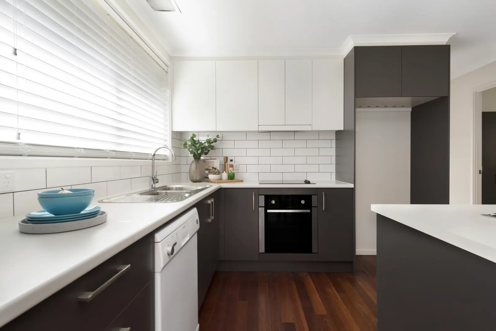 White overhead cabinetry and bench run in the Giralang kitchen