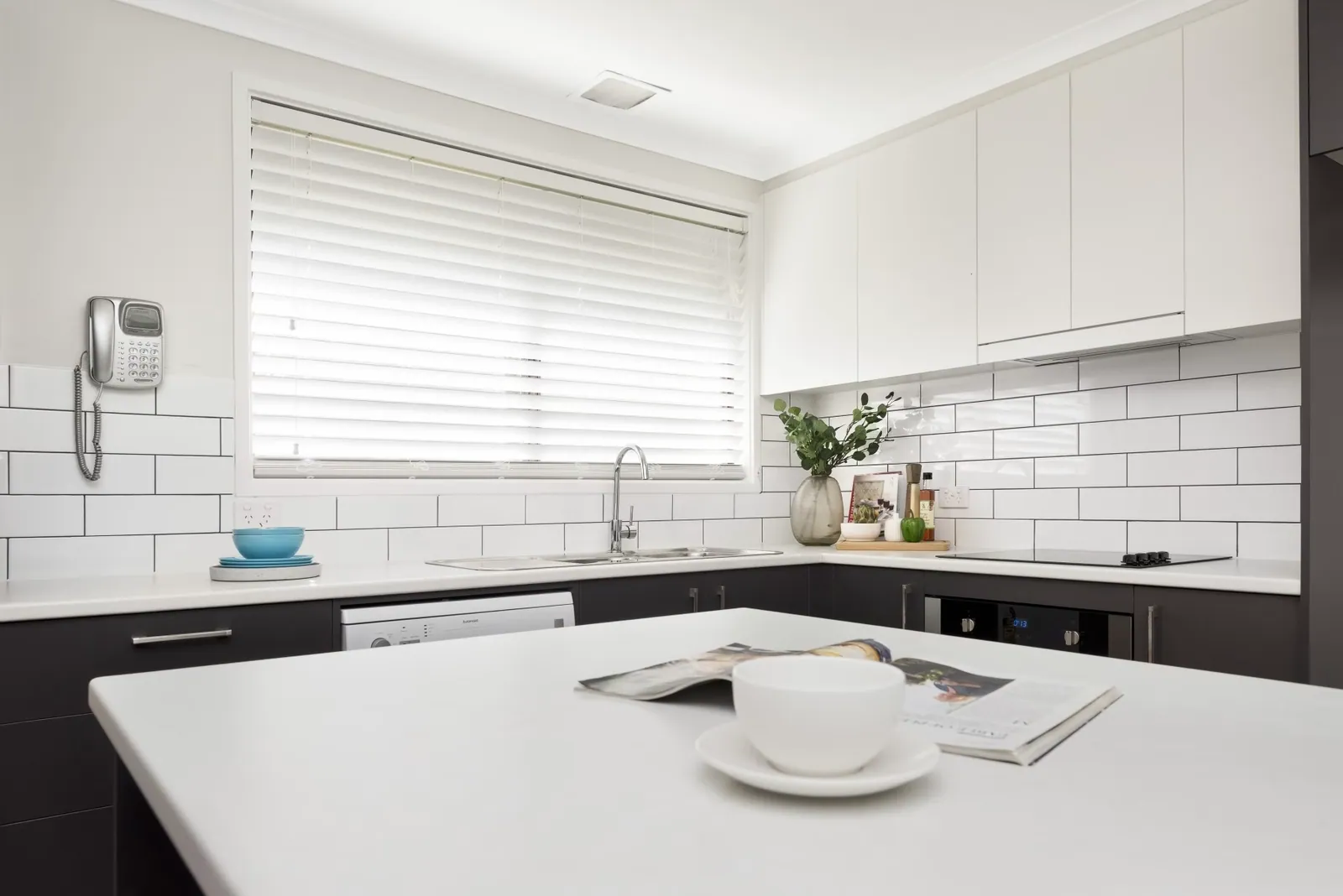 Sink, window and white benchtop in the Giralang kitchen