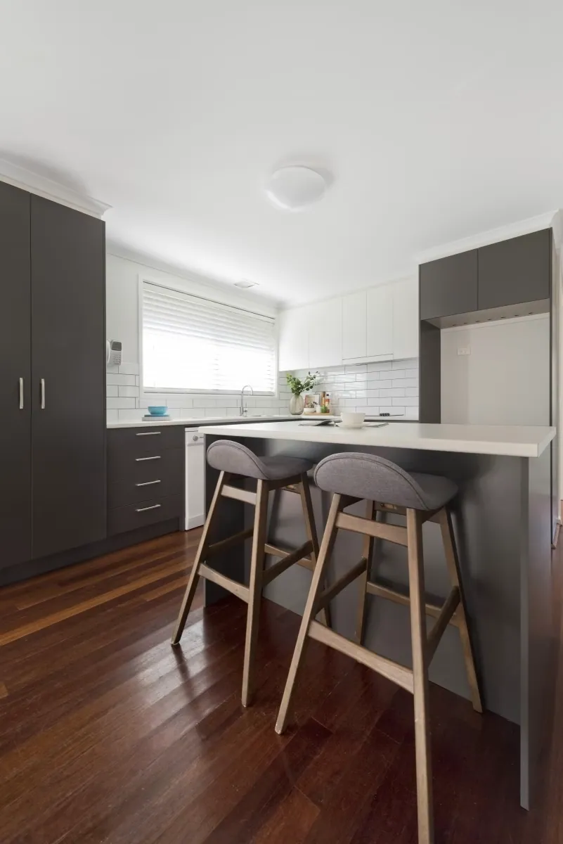 Dining table beside the Giralang kitchen with timber flooring