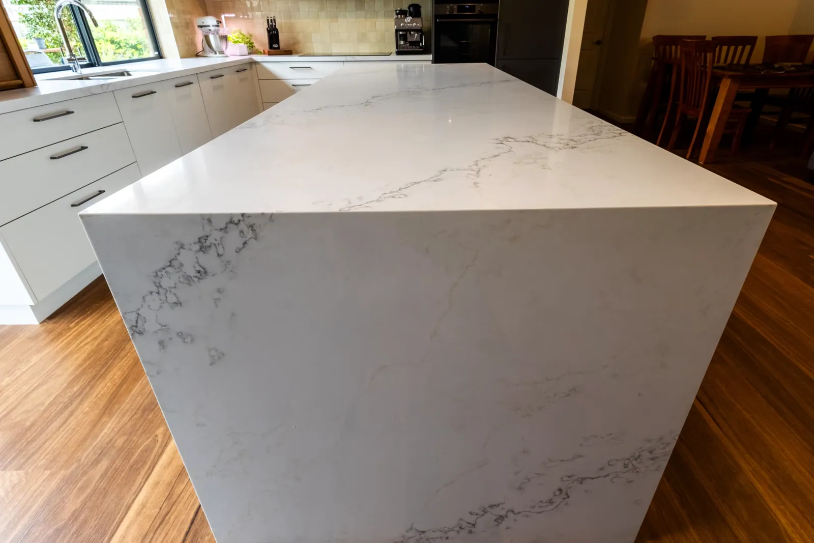 Mitred waterfall end on the Kaleen island benchtop above timber flooring