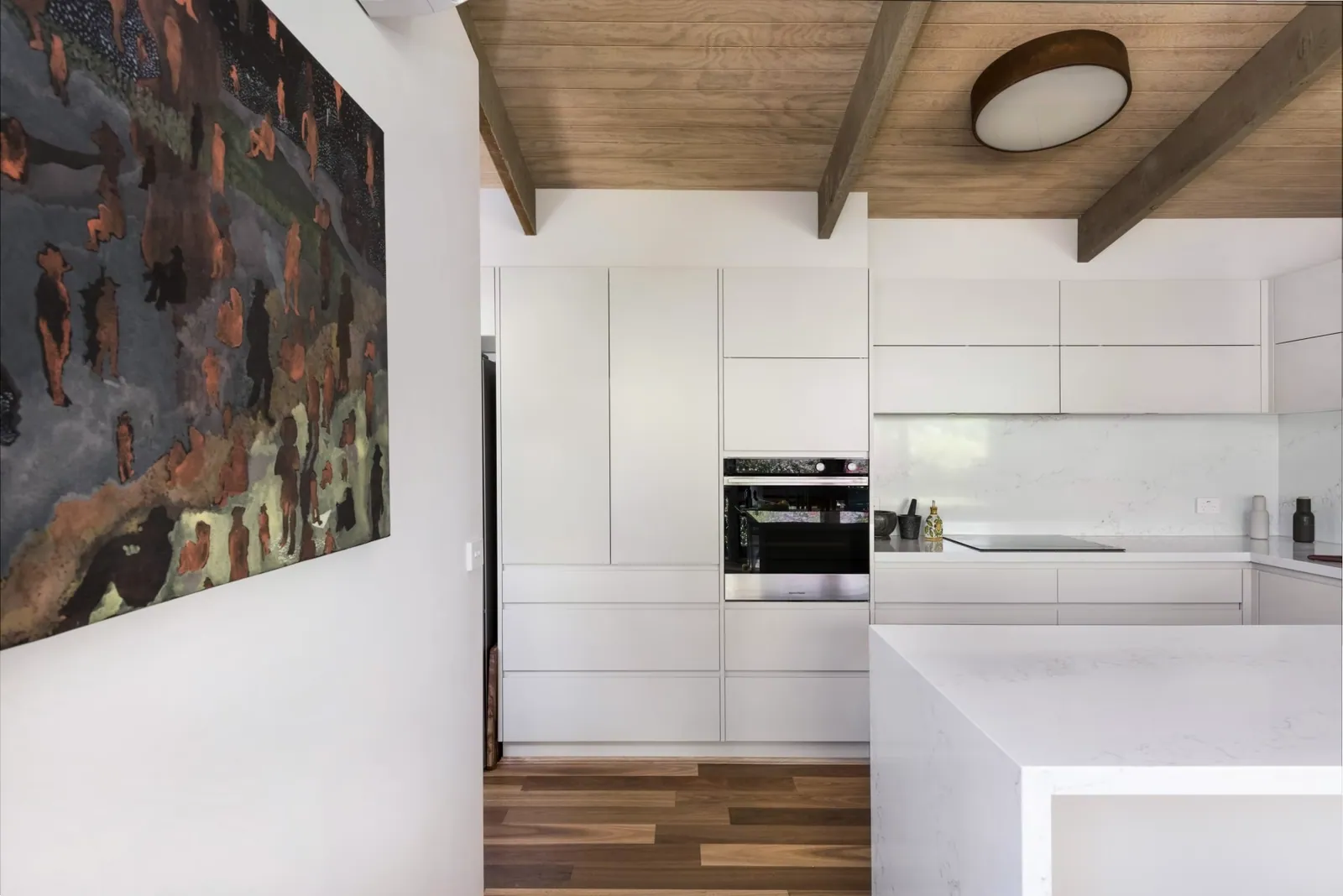Mawson kitchen under the raked timber ceiling with exposed beams
