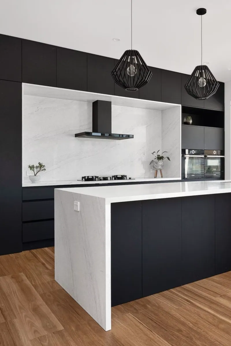 Murrumbateman kitchen with black cabinetry, a stone-look island and timber flooring
