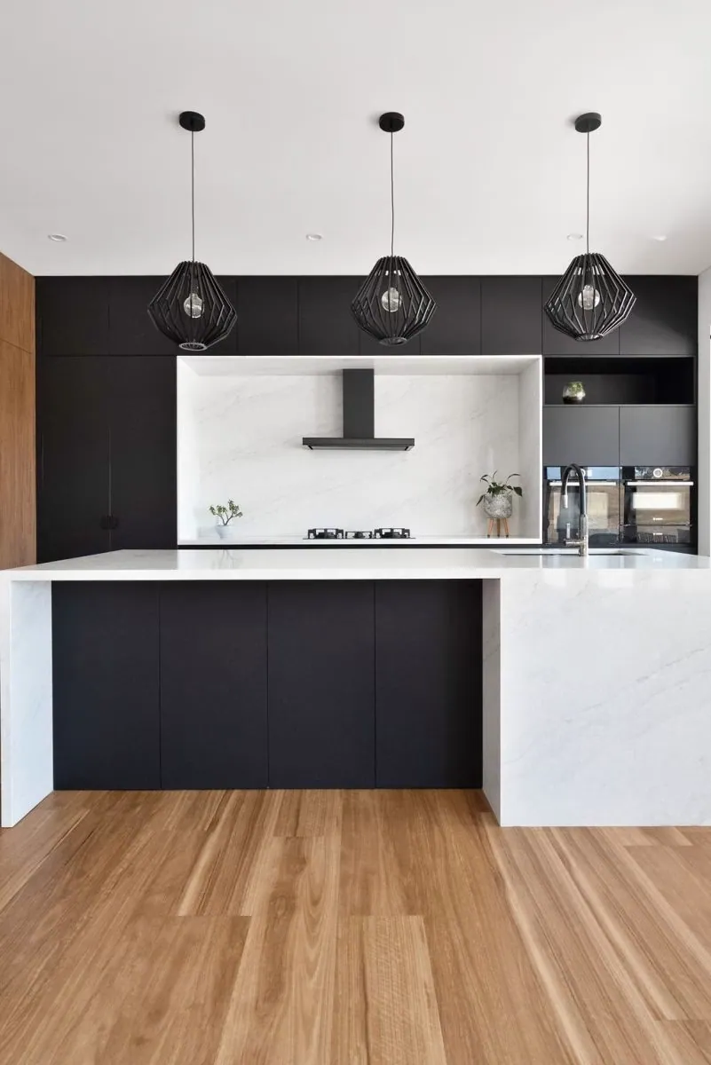 Long black bench run and white stone-look island in the Murrumbateman kitchen