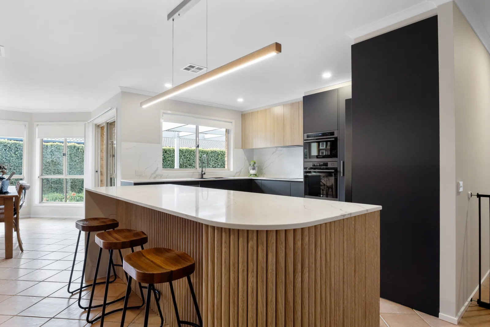 Nicholls kitchen island and bench runs looking through to the dining area