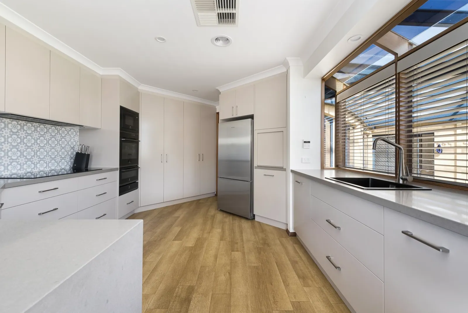 Light grey cabinetry and long bench run in the Nicholls kitchen