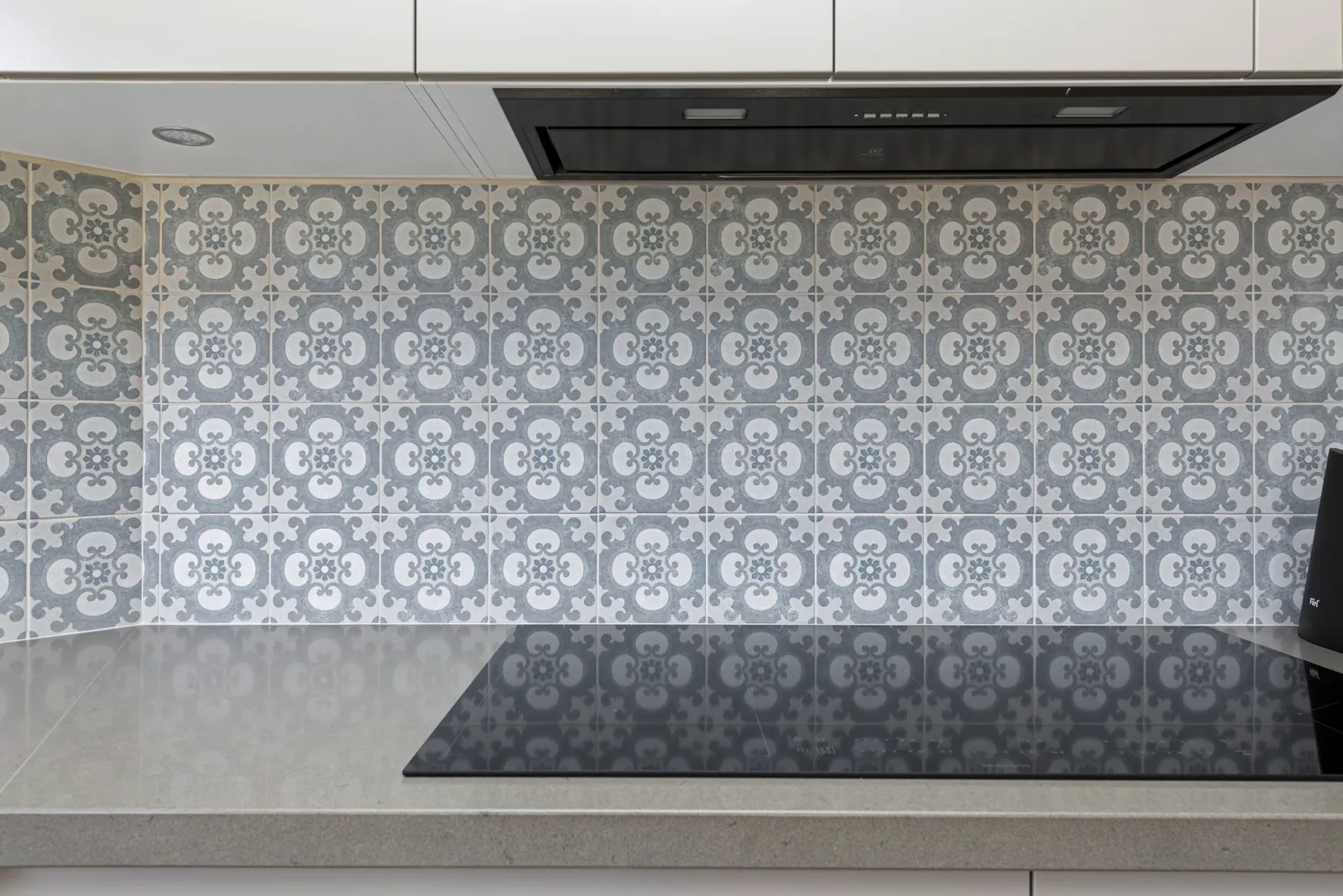 Patterned tiled splashback behind the cooktop in the Nicholls kitchen