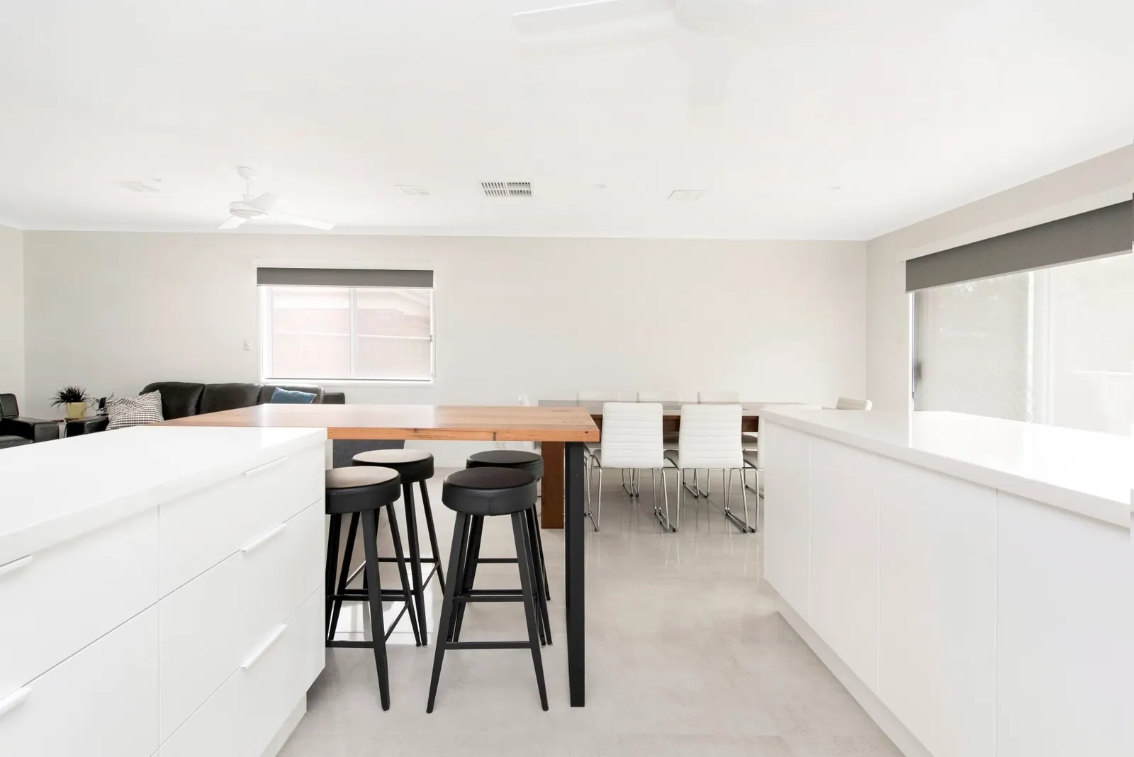Long white island with a timber breakfast bar in the Palmerston kitchen