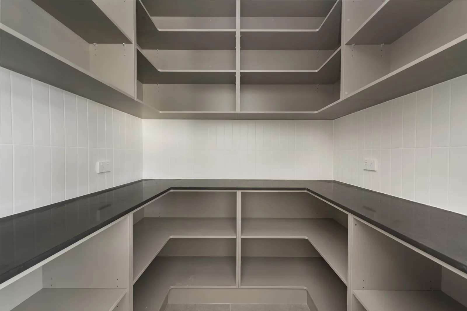 Walk-in pantry with full-height shelving beside the Taylor kitchen