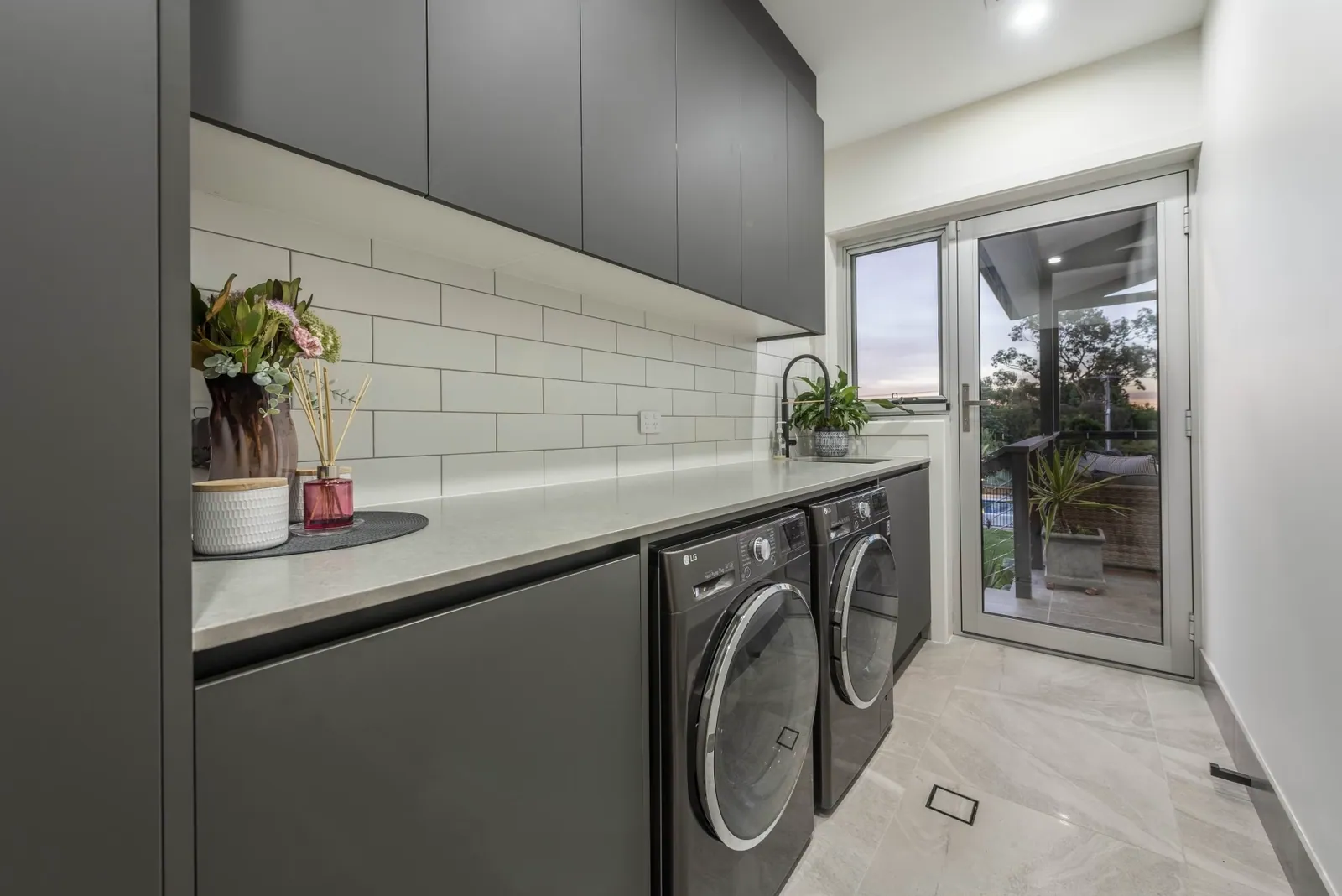 Matching dark grey laundry joinery in the Weetangera home