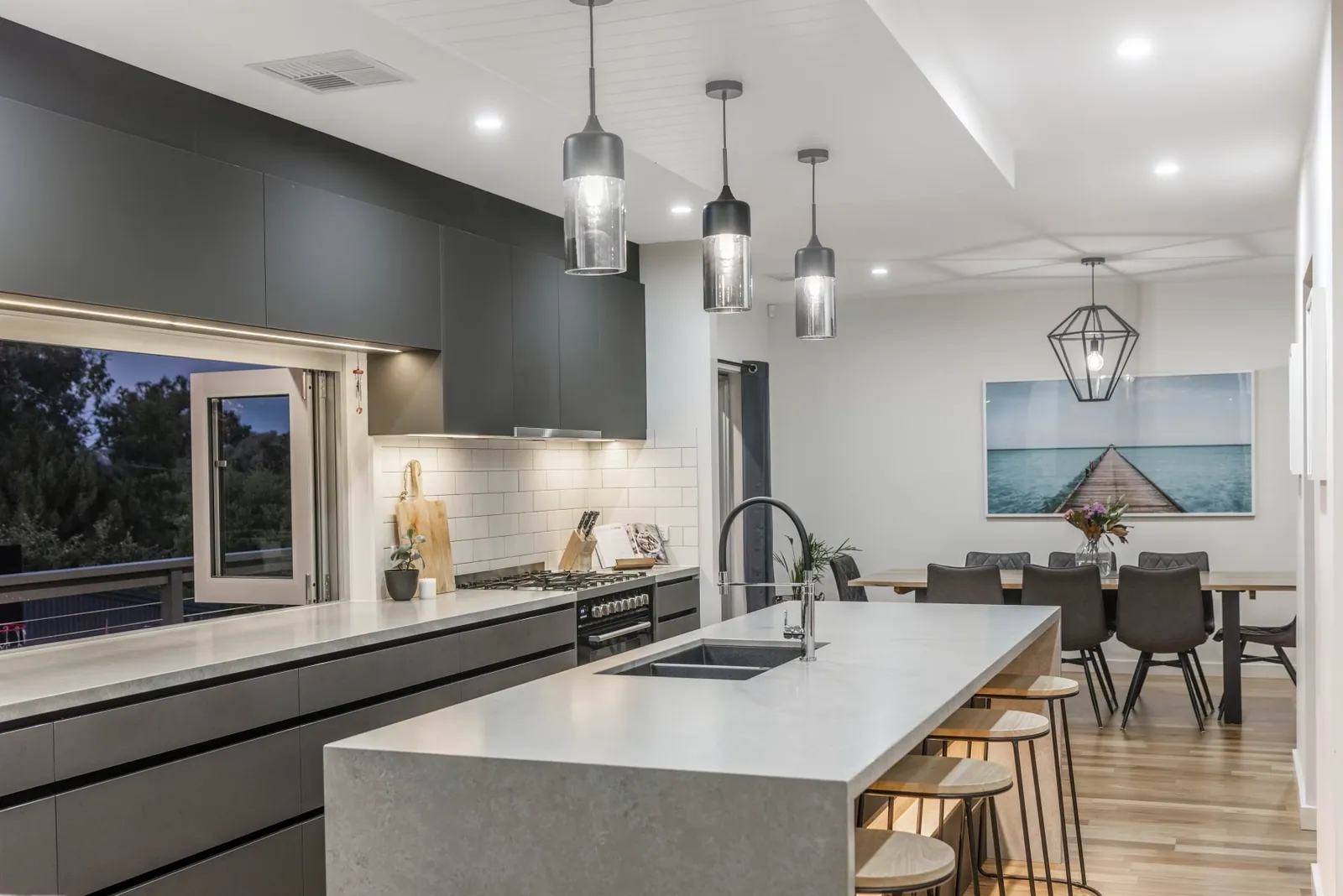 Weetangera kitchen and dining area with pendant lighting over the island
