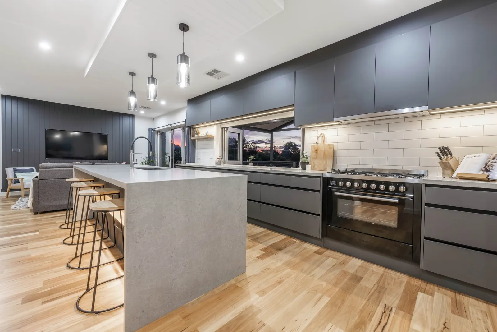Freestanding cooker and dark grey bench run in the Weetangera kitchen